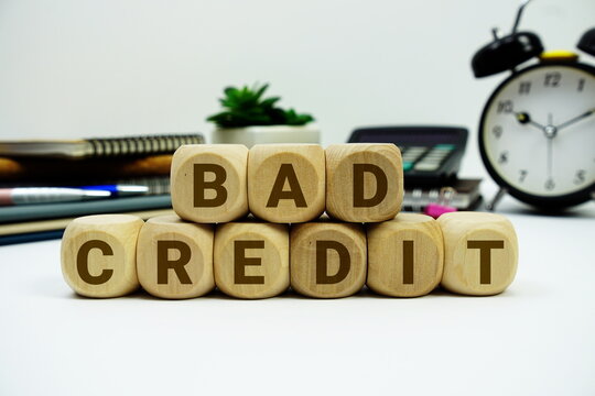 Bad Credit alphabet letters with calculator and alarm clock on white background