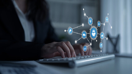 A businesswoman typing on a keyboard in a contemporary office, surrounded by a digital network...