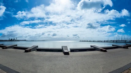 Stunning panoramic view of Corio Bay at the Geelong waterfront under a bright blue sky with soft white clouds. Victoria, Australia © Adam Calaitzis