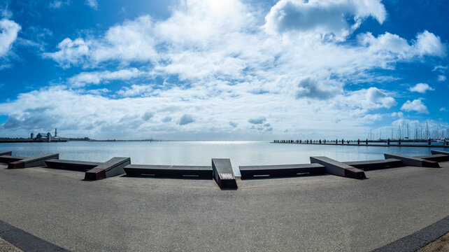 Stunning panoramic view of Corio Bay at the Geelong waterfront under a bright blue sky with soft white clouds. Victoria, Australia