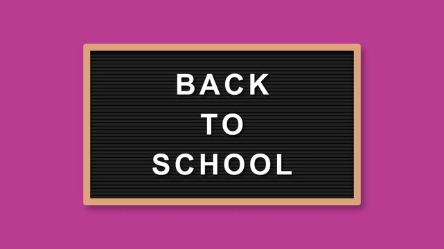 Back to school message displayed on a plastic letter board against a vibrant pink background in this animated video footage