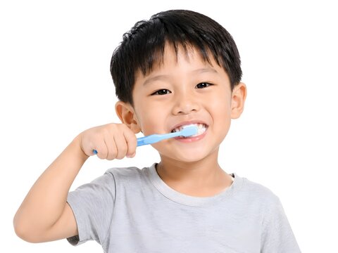 Cute boy brushing teeth on white background isolated