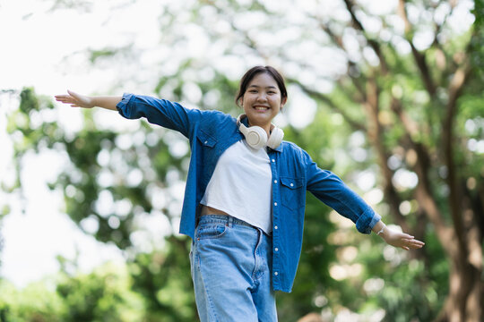 Young woman enjoying freedom and nature in park