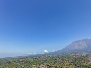 Fototapeta premium Panoramic View of Mountain Landscape and Forest Under Clear Blue Sky