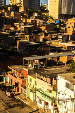 An aerial detailed view of the crowded Morro do Piolho favela community (also known as Sonia Ribeiro) composed of brick houses next to the Roberto Marinho Avenue 