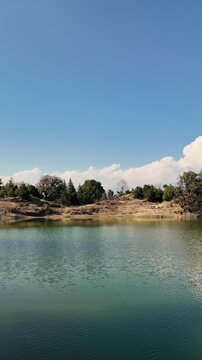 Scenic Deoria Tal lake near Chopta Uttarakhand with mountain views and blue sky