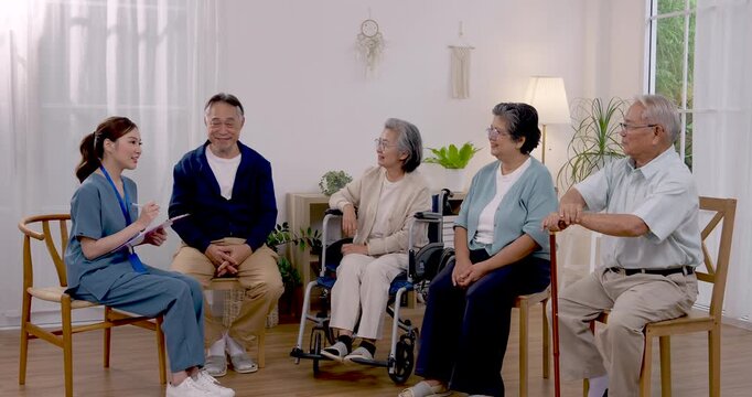 Professional nurse talks with Asian senior group during rehabilitation consultation in assisted living center, discussing exercise, mobility support, healthy aging, wellness goals and daily care.