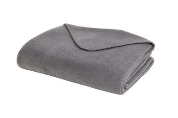 Soft gray fleece blanket is neatly folded and isolated on a clean white background, showcasing its cozy texture and stitched edge © Chinases