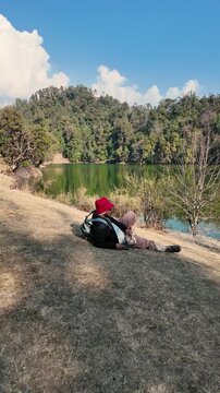 Hiker resting by Deoria Tal lake near Tungnath temple in Chopta Uttarakhand India