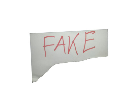 A torn piece of white paper with the word fake written in red ink isolated on transparent background