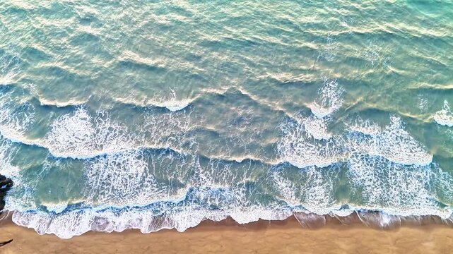 empty sandy beach with white sand and dramatic ocean waves creating peaceful surf patterns, serene turquoise tropical vacation beach