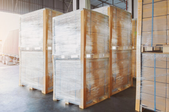 Bulk of Package Boxes Wrapped Plastic on Pallets. Storage Distribution Warehouse. Cartons, Cardboard Boxes. Supply Chain, Supplies Goods Shipment. Warehouse Shipping Logistics