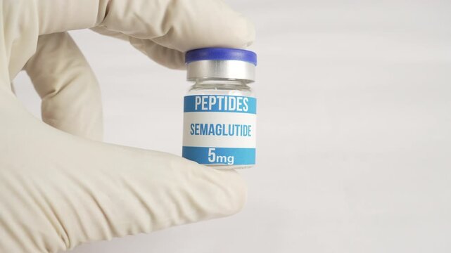Researcher holding a vial of semaglutide peptide, a weight loss and diabetes drug, on a white background
