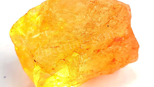 Raw yellow citrine crystal gemstone isolated on a white background