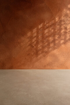 Russet plaster wall and empty counter with soft warm shadows