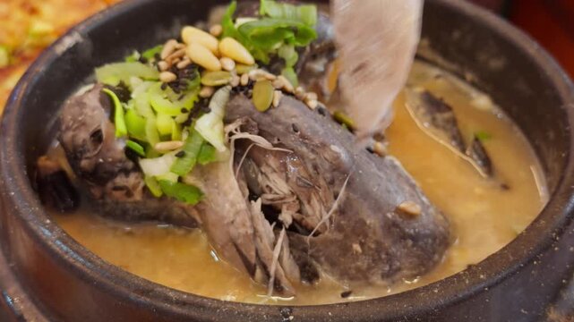Korean Black Chicken Samgyetang Chopsticks Pulling Apart Chicken Meat Close-Up