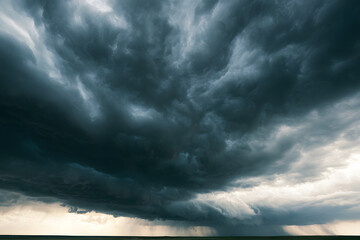 Obraz premium Overcast sky with dark storm clouds stretching across a flat horizon, accompanied by heavy rain. A scene highlighting severe weather conditions, the supremacy of nature, concerns about climate change,