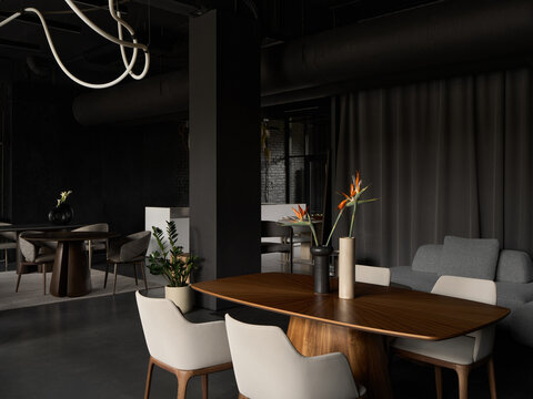 Moody dark interior with modern furniture and flowers
