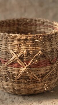 Rustic handwoven wicker basket with cross stitch pattern close up