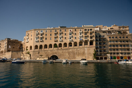 Historic limestone buildings on the Malta harbor waterfront
