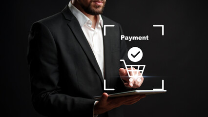 Online payment process using a tablet in a dark setting by a man in a suit © fotofabrika