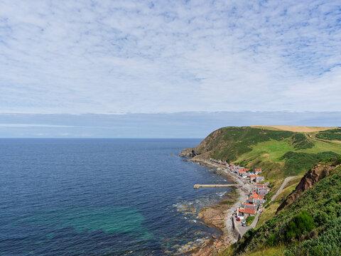 The Old Fishing Village of Crovie with its distinctive stone pier or Breakwater along which the Herring Boats used to berth to offload their Catch.