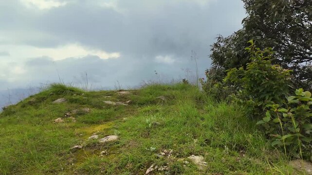 Slow Reveal From Rocky Mountain Ridge to Mist-Filled Forest Valley in Uttarakhand