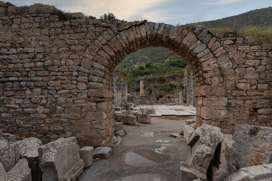 Ancient stone archway leading into the historical ruins of the commercial agora in the ancient city of Ephesus near Selcuk, Turkey