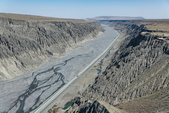 Panoramic Aerial View of Dushanzi Grand Canyon and Kuitun River in Xinjiang: Winding River, Geological Formations, Mudstone Strata along Duku Highway