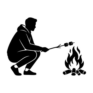 Man roasting marshmallows over campfire at night outdoors