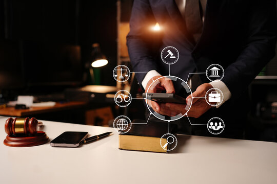 Lawyer working with law book and digital legal tech icons in office