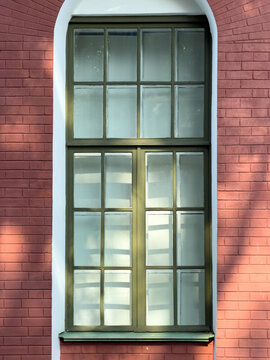 Arched window framed in red brick