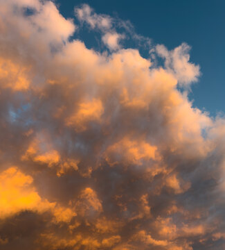 Golden clouds glow against deep blue sky