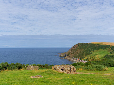 The view east from the Car Park and Viewpoint on the Cliffs of old Red Sandstone above the old Fishing Village of Crovie in the Moray Firth,