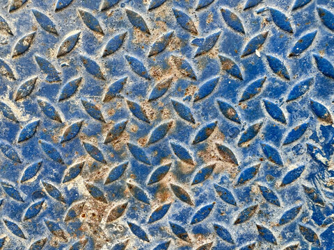 Blue weathered diamond plate texture background with rust and dirt