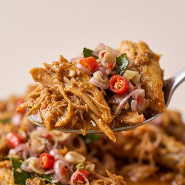 Close Up Shredded Ayam Betutu with Sambal Matah on Spoon AI Generated
