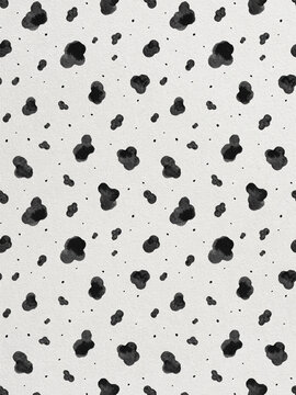 Seamless cow print pattern with black watercolor spots