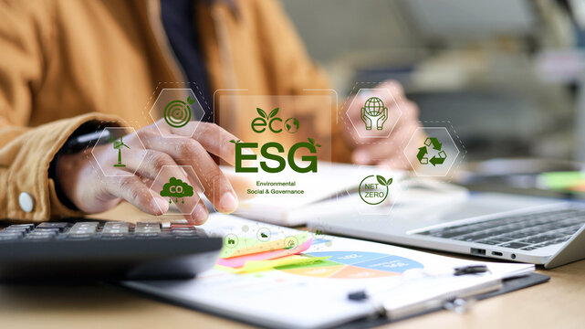 Business person using calculator with ESG virtual icon, environmental social governance concept, net zero carbon emission, sustainable investment.