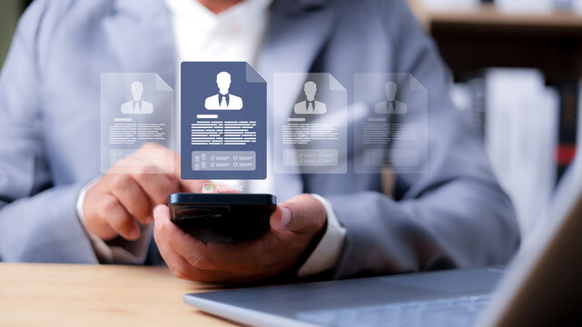 HR manager using smartphone to review digital resume profiles, online recruitment process, candidate selection and approval for job application.