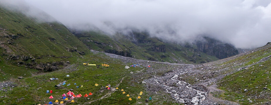 Aerial Drone View of Balu Ka Ghera Campsite on the Hampta Pass Trek Near Manali, Himachal Pradesh with Mountain Tents, Rugged Rocky Mountains and Scenic High Altitude Valley