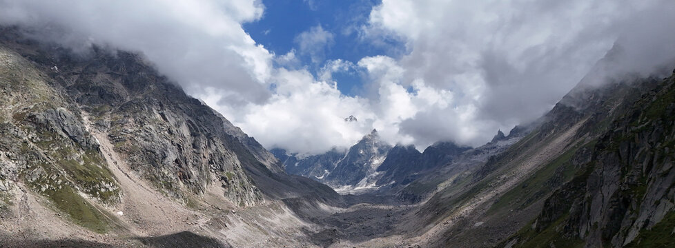 Aerial Landscape View from Lahaul Valley, Himachal Pradesh Toward Deo Tibba and Indrasan Mountains Covered by Dramatic Clouds and Mist