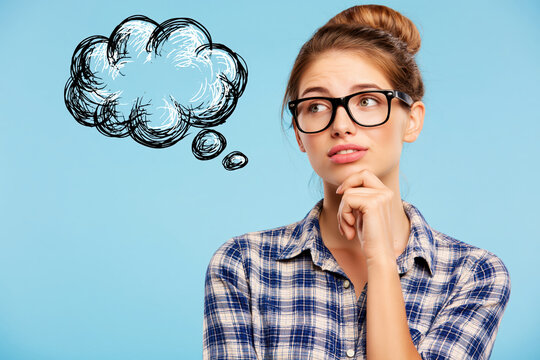 Woman with thought bubble sketch showing creative thinking and uncertainty in studio portrait with blue background and copy space