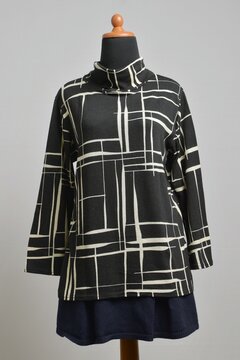 Black turtleneck sweater with abstract line pattern with navy skirt on mannequin