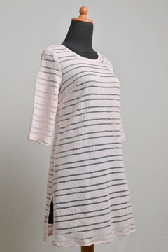 Soft pink stripes sheer sweater dress on a mannequin display