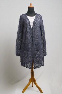 Sheer navy long cardigan with soft pink striped sweater dress on a dress form