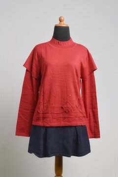 Red ruffle long sleeves sweater with mini skirt on a mannequin display