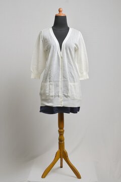Off-white button up cardigan with 3/4 sleeves with navy mini skirt