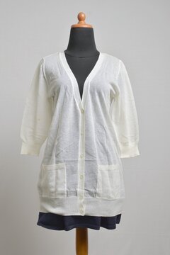 Off-white button up cardigan with 3/4 sleeves with navy mini skirt
