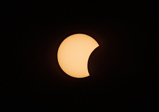 Partial solar eclipse against a black sky background