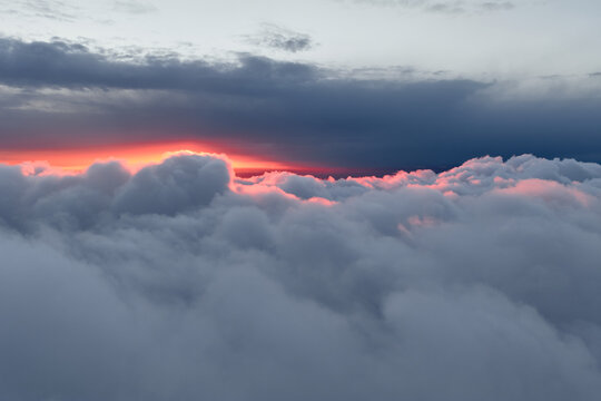 Dramatic red sunset peeking over the clouds